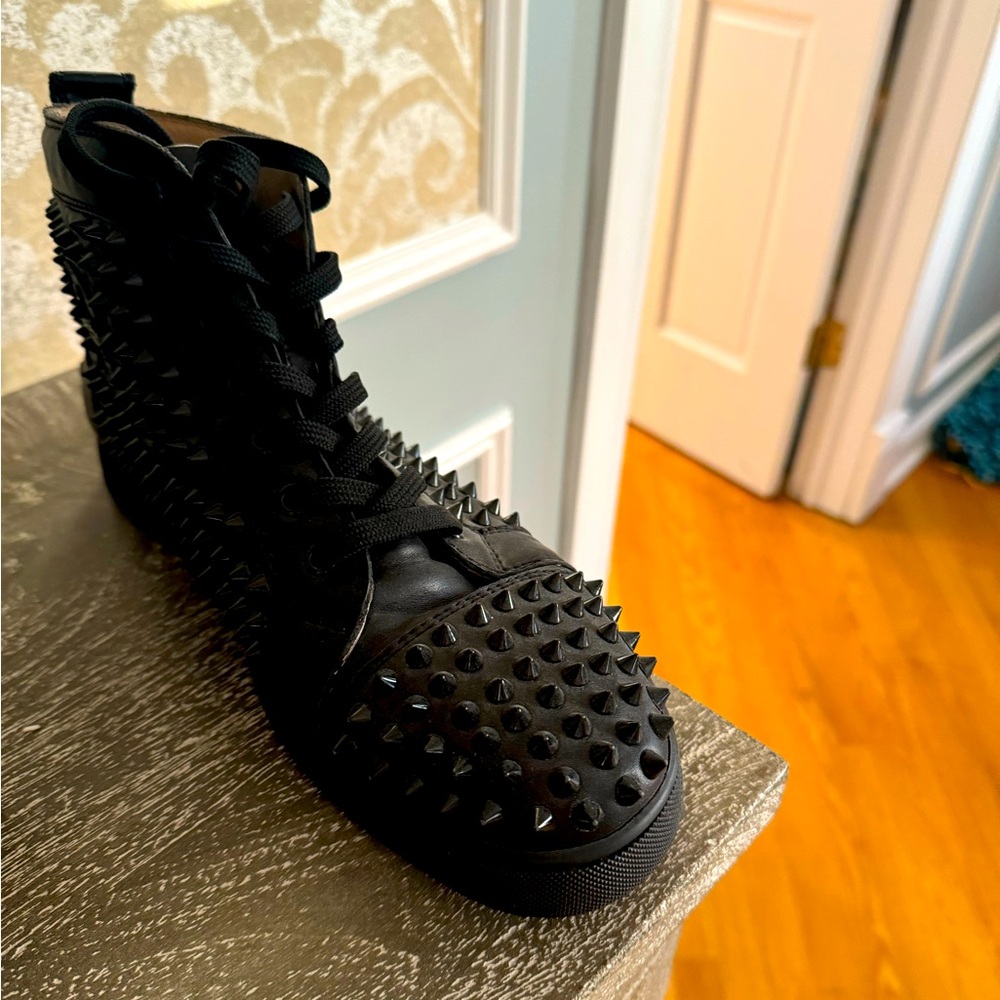 Pair of louboutin red bottom spiked high top kicks